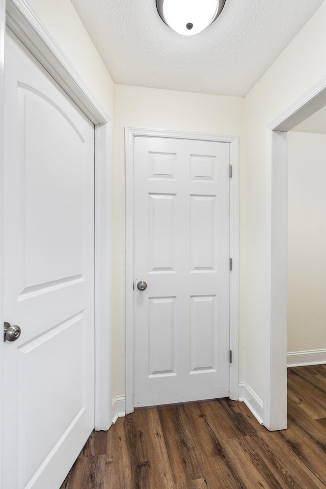 1331 Phils Dr, Chattanooga, TN 37421 - hallway featuring dark wood-style flooring, baseboards, and a textured ceiling