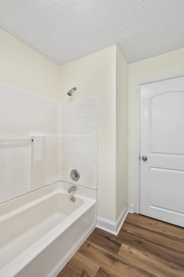 1331 Phils Dr, Chattanooga, TN 37421 - full bathroom featuring wood finished floors, shower / bathtub combination, a textured ceiling, and baseboards