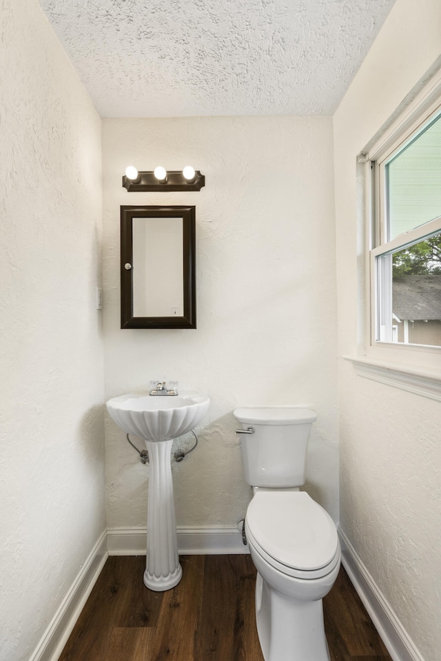 1331 Phils Dr, Chattanooga, TN 37421 - half bathroom featuring baseboards, a textured ceiling, wood finished floors, toilet, and a textured wall