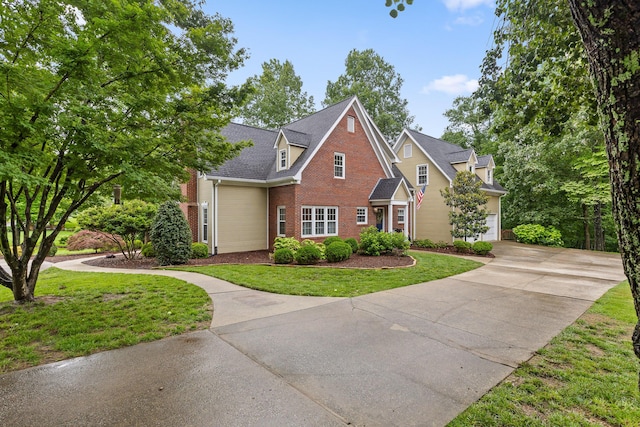9334 Royal Mountain Dr, Chattanooga, TN 37421 - traditional-style house featuring brick siding, concrete driveway, a front lawn, and a garage