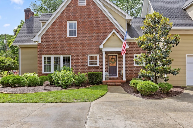 9334 Royal Mountain Dr, Chattanooga, TN 37421 - traditional-style house featuring a chimney, brick siding, and roof with shingles