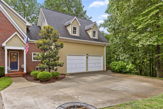 9334 Royal Mountain Dr, Chattanooga, TN 37421 - view of front of property featuring a garage, concrete driveway, roof with shingles, and brick siding