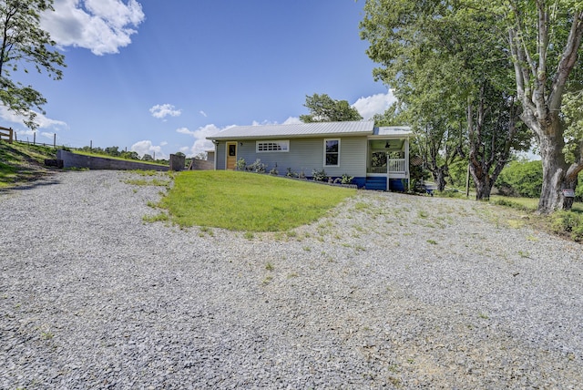 109 S Clear Springs Rd, Limestone, TN 37681 - rear view of property with metal roof, a lawn, and gravel driveway