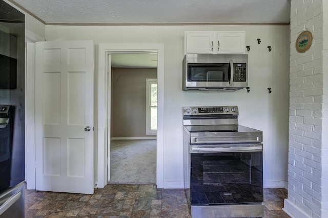 109 S Clear Springs Rd, Limestone, TN 37681 - kitchen with appliances with stainless steel finishes, crown molding, white cabinets, a textured ceiling, and dark stone finish floors