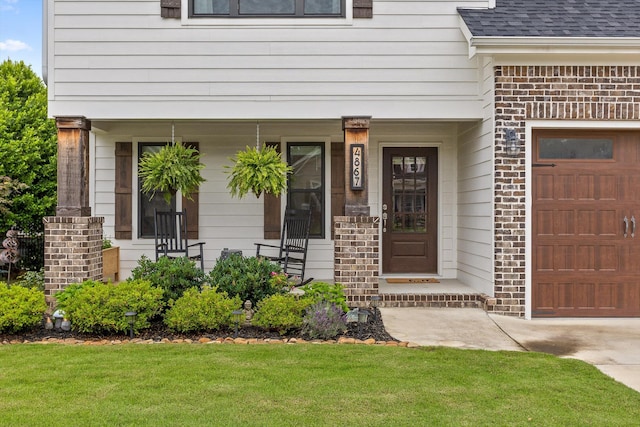 4867 Preserve Dr, Chattanooga, TN 37416 - property entrance with an attached garage, covered porch, a lawn, roof with shingles, and brick siding