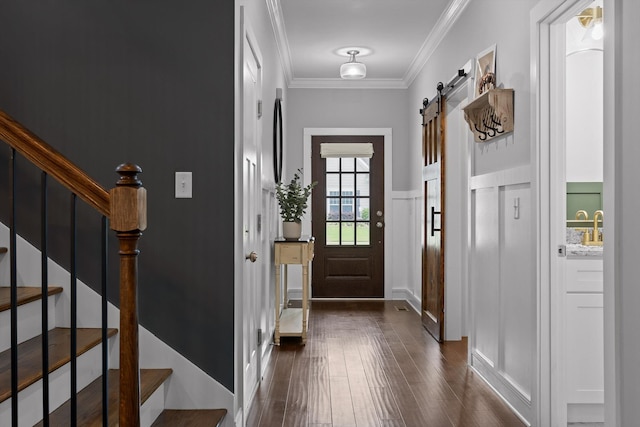 4867 Preserve Dr, Chattanooga, TN 37416 - entrance foyer with dark wood-style floors, a decorative wall, crown molding, stairs, and a barn door