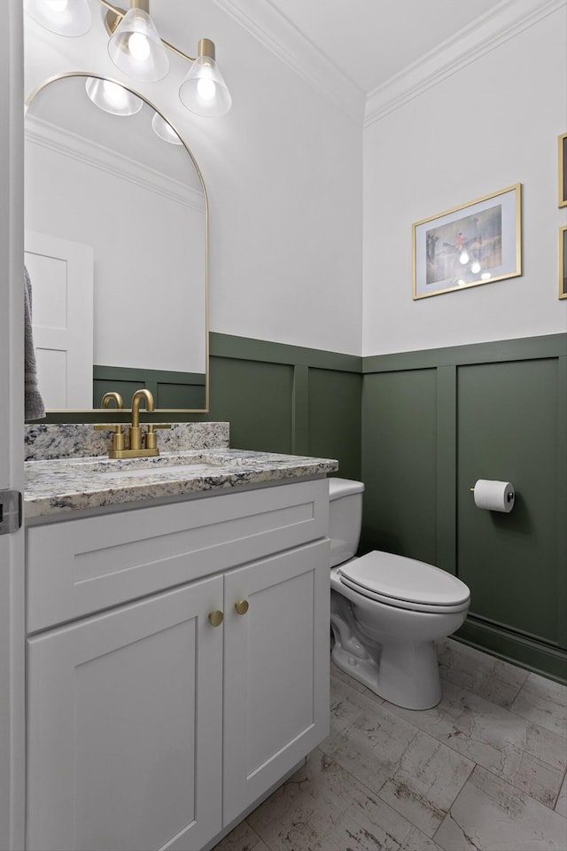 4867 Preserve Dr, Chattanooga, TN 37416 - bathroom with marble look tile flooring, ornamental molding, toilet, vanity, and a wainscoted wall