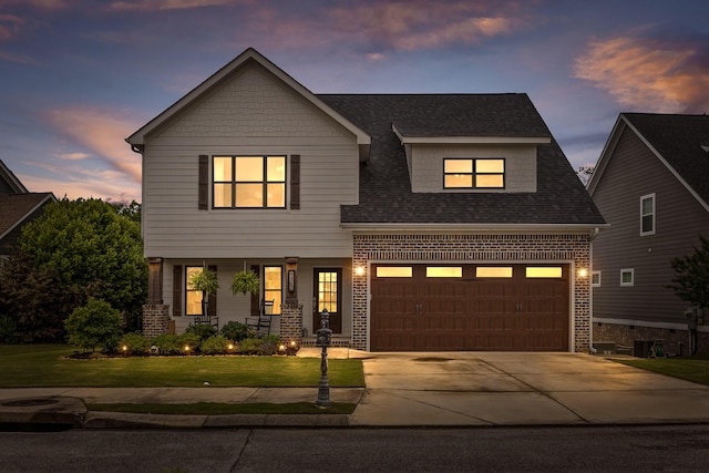 4867 Preserve Dr, Chattanooga, TN 37416 - view of front of house featuring driveway, a yard, brick siding, a garage, and a porch