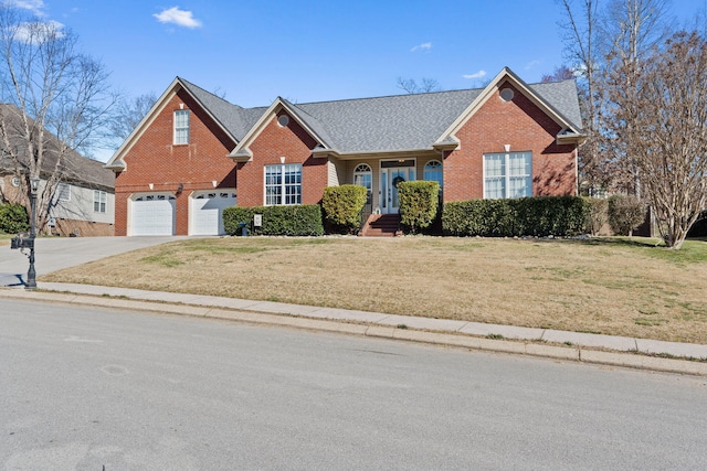 1549 Leighton Dr, Soddy Daisy, TN 37379 - traditional home featuring brick siding, an attached garage, driveway, and a front yard