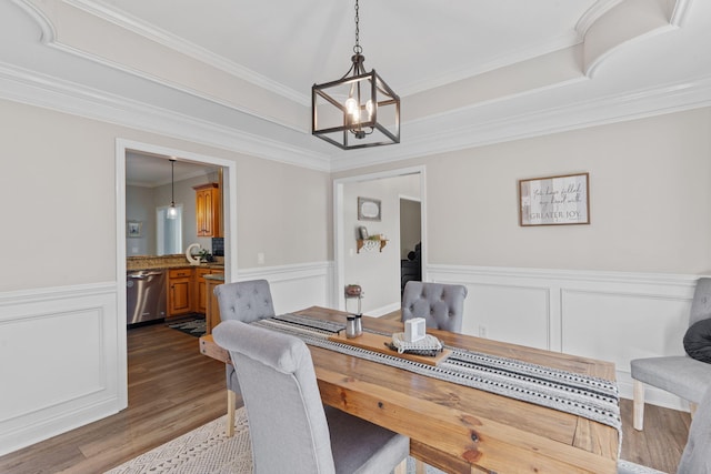 1549 Leighton Dr, Soddy Daisy, TN 37379 - dining room with a chandelier, dark wood-type flooring, a wainscoted wall, crown molding, and a decorative wall