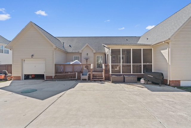 1549 Leighton Dr, Soddy Daisy, TN 37379 - back of house featuring a sunroom, a wooden deck, roof with shingles, and a garage