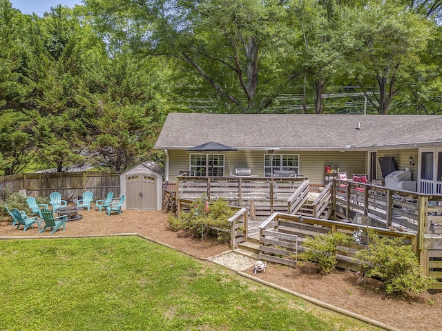 201 N Tibbs Rd, Dalton, GA 30720 - back of property with an outdoor fire pit, a wooden deck, and roof with shingles