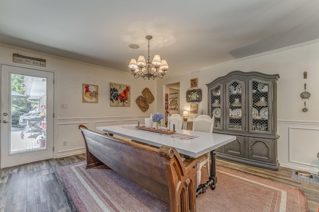 201 N Tibbs Rd, Dalton, GA 30720 - dining space with a chandelier, dark wood finished floors, a decorative wall, crown molding, and a wainscoted wall