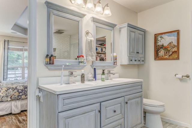 201 N Tibbs Rd, Dalton, GA 30720 - full bath featuring double vanity, wood finished floors, toilet, ensuite bath, and a shower