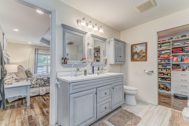 201 N Tibbs Rd, Dalton, GA 30720 - full bathroom featuring double vanity, ensuite bath, wood finished floors, recessed lighting, and toilet