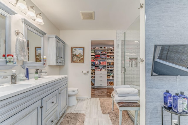 201 N Tibbs Rd, Dalton, GA 30720 - full bath with double vanity, a stall shower, toilet, and a spacious closet