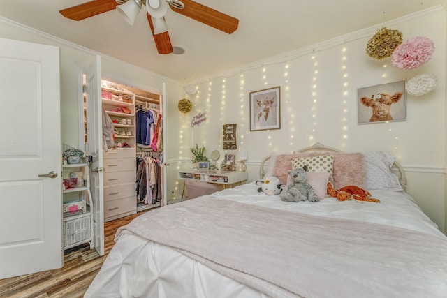 201 N Tibbs Rd, Dalton, GA 30720 - bedroom with wood finished floors, a spacious closet, a closet, ornamental molding, and a ceiling fan