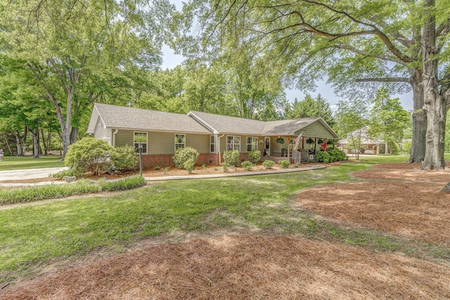 201 N Tibbs Rd, Dalton, GA 30720 - ranch-style house with a porch, a front lawn, brick siding, and roof with shingles