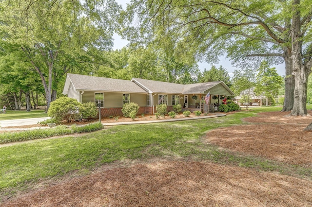 201 N Tibbs Rd, Dalton, GA 30720 - ranch-style home with covered porch, a front lawn, and a shingled roof