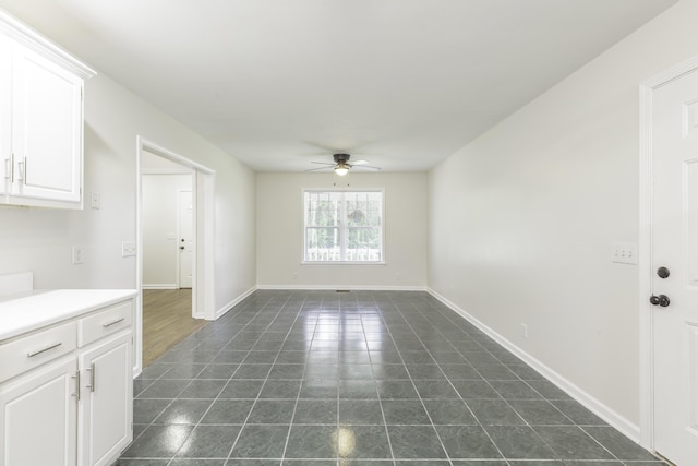 3172 Reed Rd, Tunnel Hill, GA 30755 - unfurnished dining area featuring ceiling fan, dark tile patterned flooring, and baseboards