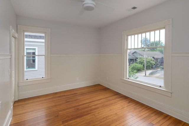 1501 Chamberlain Ave, Chattanooga, TN 37404 - spare room featuring hardwood / wood-style flooring, a wainscoted wall, a ceiling fan, and baseboards