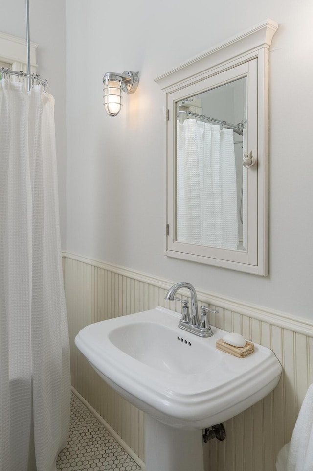 1501 Chamberlain Ave, Chattanooga, TN 37404 - bathroom with wainscoting, a sink, tile patterned floors, and a shower with curtain
