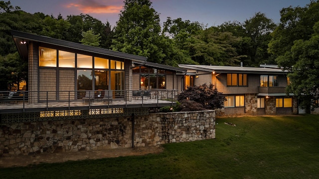 702 S Crest Rd, Chattanooga, TN 37404 - back of house at dusk featuring a yard and stone siding