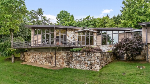702 S Crest Rd, Chattanooga, TN 37404 - rear view of property featuring stone siding, a lawn, and a sunroom