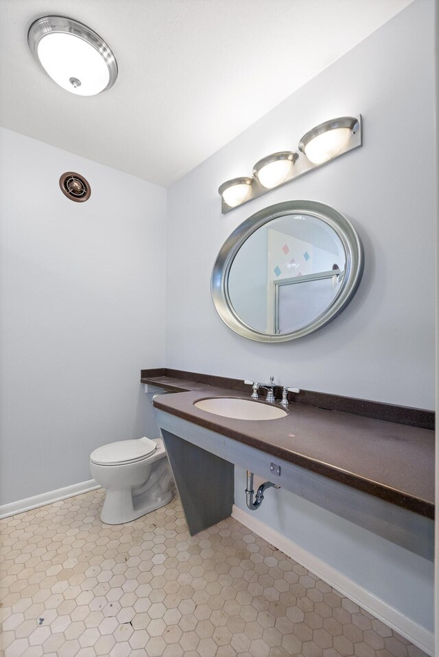 702 S Crest Rd, Chattanooga, TN 37404 - bathroom with a sink, toilet, and baseboards