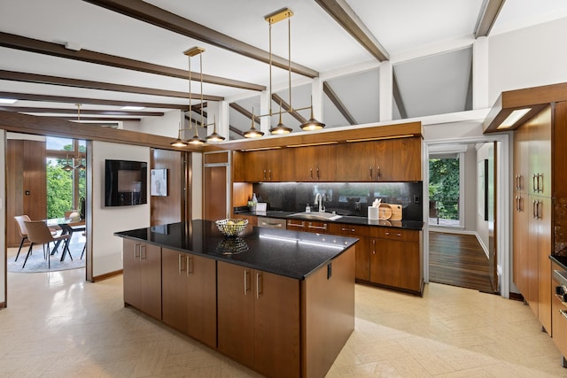 702 S Crest Rd, Chattanooga, TN 37404 - kitchen featuring a sink, decorative backsplash, a kitchen island, baseboards, and brown cabinetry