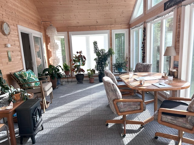 308 Bennie Camp Rd, Dunlap, TN 37327 - sunroom featuring plenty of natural light, wood walls, wooden ceiling, a wood stove, and carpet