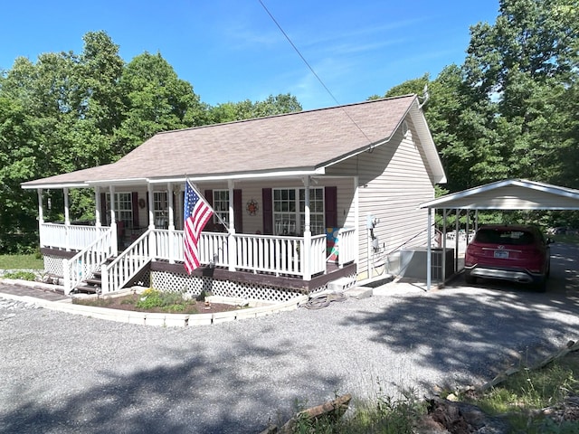 308 Bennie Camp Rd, Dunlap, TN 37327 - view of front of house with a carport, covered porch, roof with shingles, and asphalt driveway