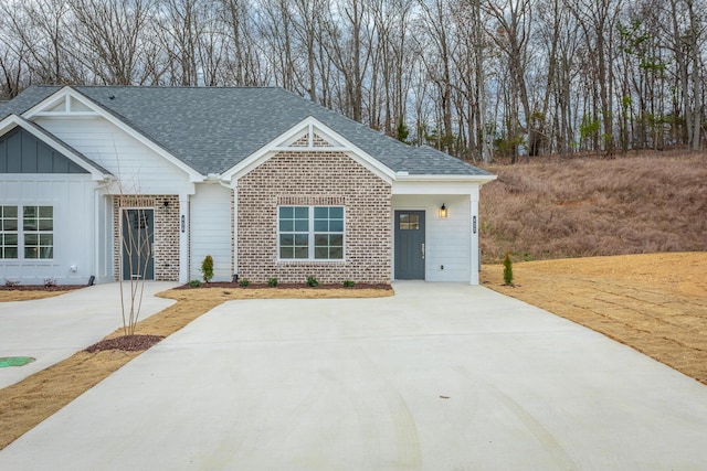 356 NE Bellingham Dr Unit 3D, Cleveland, TN 37312 - view of front of home featuring board and batten siding, a shingled roof, and brick siding