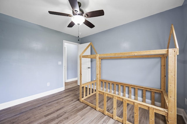 1804 Staghorn Dr, Soddy Daisy, TN 37379 - unfurnished bedroom with baseboards, wood finished floors, and ceiling fan