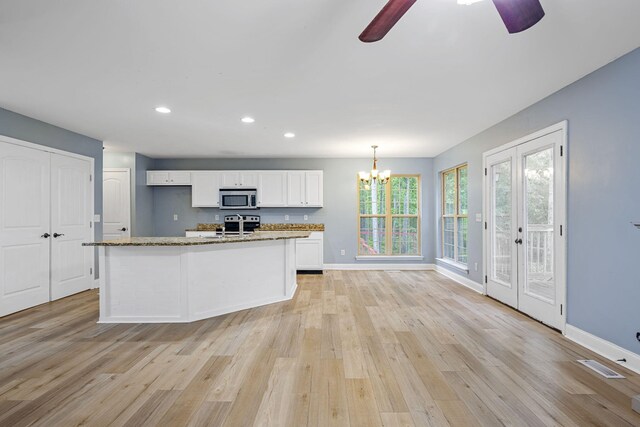 1804 Staghorn Dr, Soddy Daisy, TN 37379 - kitchen with stainless steel microwave, white cabinetry, light wood finished floors, a ceiling fan, and recessed lighting