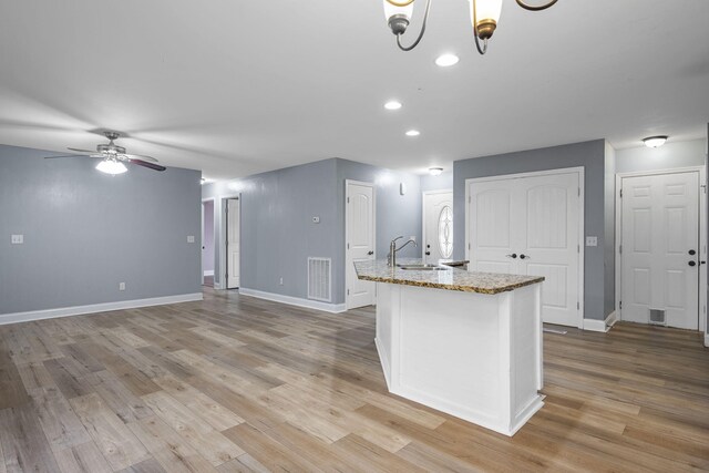 1804 Staghorn Dr, Soddy Daisy, TN 37379 - kitchen with a sink, baseboards, light wood-type flooring, light stone counters, and recessed lighting