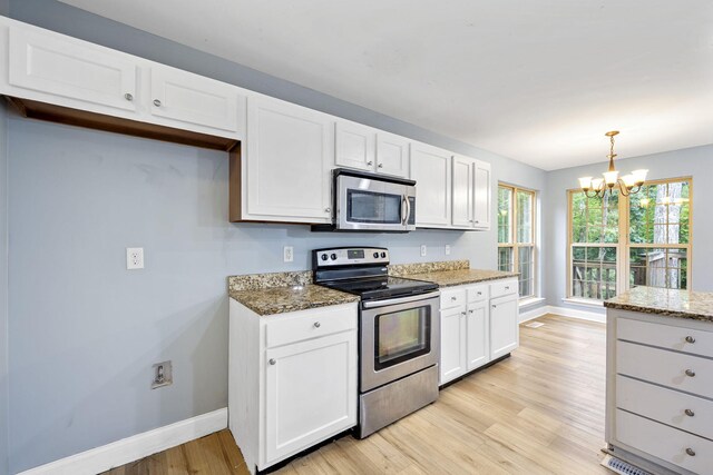 1804 Staghorn Dr, Soddy Daisy, TN 37379 - kitchen with appliances with stainless steel finishes, baseboards, a chandelier, light wood finished floors, and white cabinets