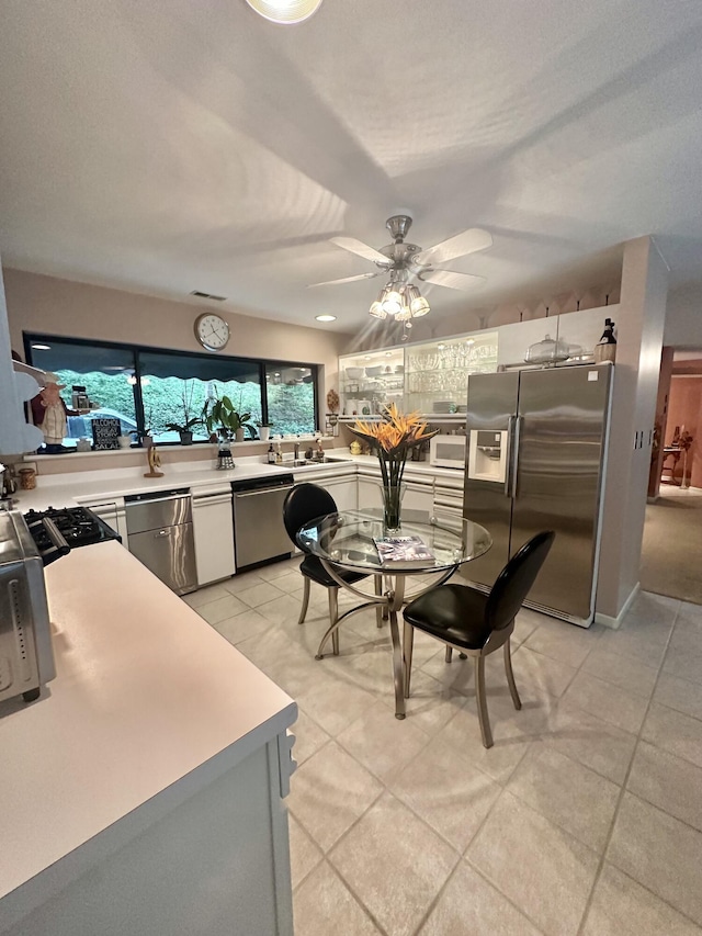 413 Fern Trl, Signal Mountain, TN 37377 - kitchen featuring stainless steel appliances, light countertops, ceiling fan, light tile patterned floors, and white cabinets