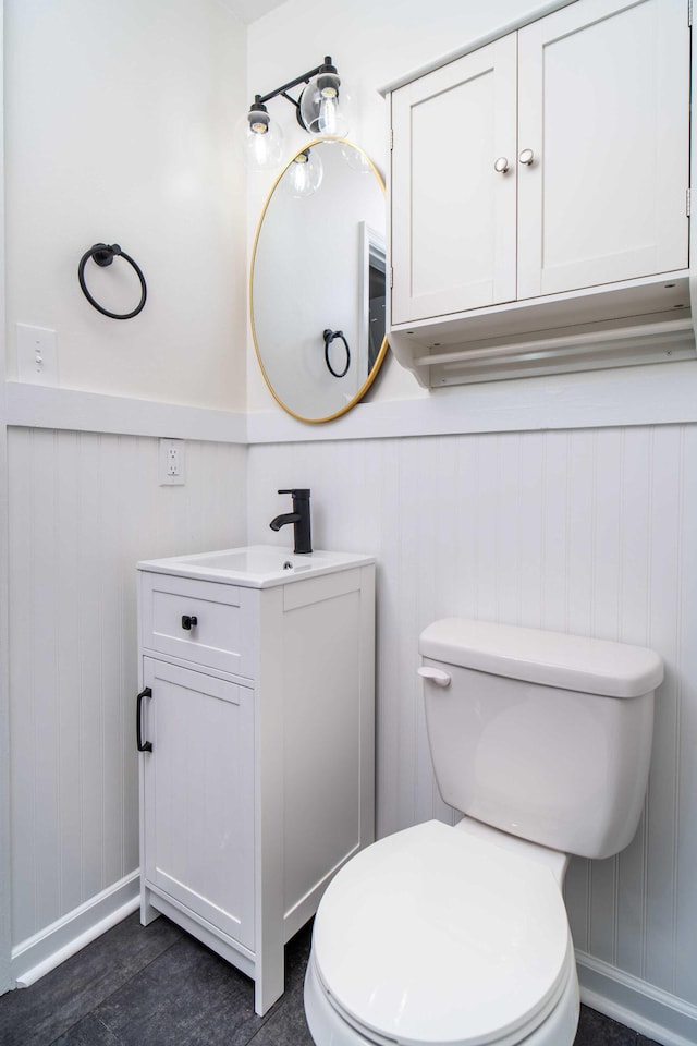 1306 Phyllis Ln, Chattanooga, TN 37421 - bathroom featuring vanity, toilet, baseboards, and wainscoting