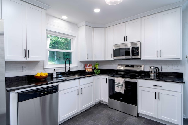 1306 Phyllis Ln, Chattanooga, TN 37421 - kitchen featuring appliances with stainless steel finishes, a sink, decorative backsplash, white cabinets, and recessed lighting
