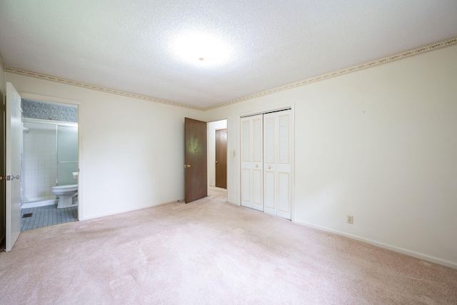 6515 Grubb Rd, Hixson, TN 37343 - unfurnished bedroom featuring a closet, carpet floors, a textured ceiling, and ensuite bath