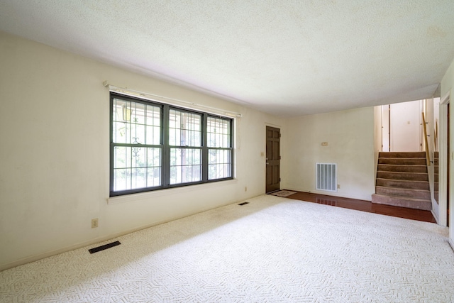 6515 Grubb Rd, Hixson, TN 37343 - carpeted spare room featuring stairs and a textured ceiling