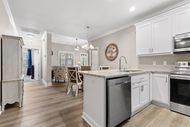 214 Camden Way Unit 38, Dalton, GA 30721 - kitchen featuring stainless steel appliances, a sink, ornamental molding, white cabinetry, and a peninsula