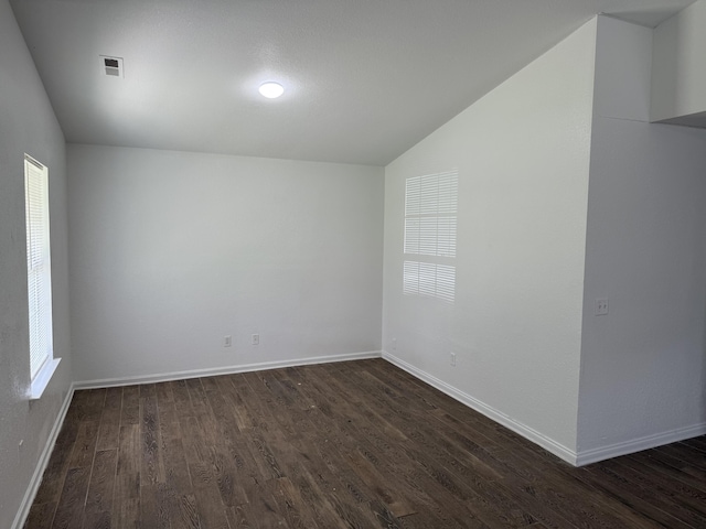 2107 Stuart St, Chattanooga, TN 37406 - empty room featuring dark wood-style floors, vaulted ceiling, and baseboards