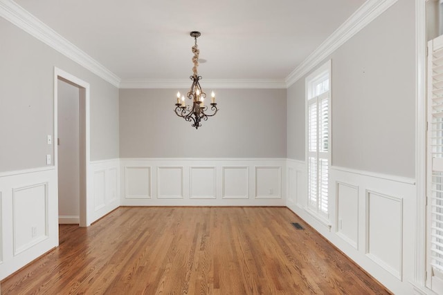 8650 Homecoming Dr, Chattanooga, TN 37421 - spare room with a chandelier, ornamental molding, wainscoting, light wood-style flooring, and a decorative wall