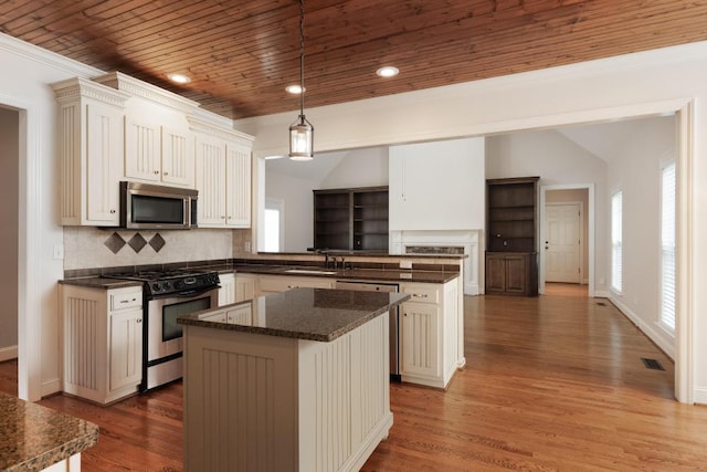 8650 Homecoming Dr, Chattanooga, TN 37421 - kitchen with appliances with stainless steel finishes, a center island, a peninsula, wooden ceiling, and wood finished floors