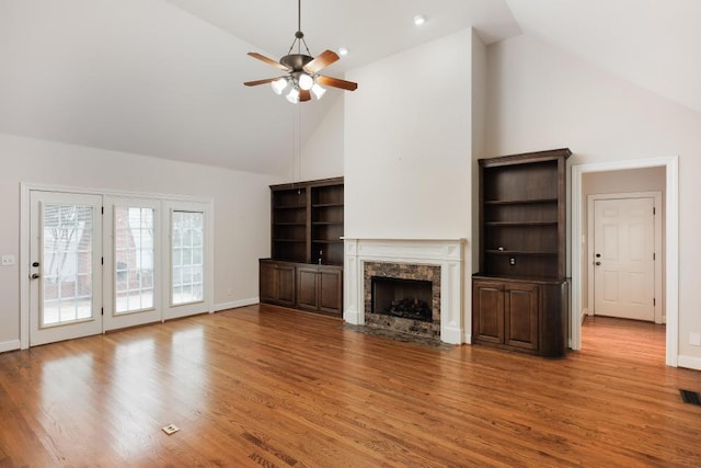 8650 Homecoming Dr, Chattanooga, TN 37421 - unfurnished living room featuring high vaulted ceiling, a fireplace with flush hearth, a ceiling fan, wood finished floors, and baseboards