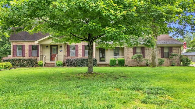 2434 Haven Cove Ln, Chattanooga, TN 37421 - view of front of property featuring a front yard, brick siding, and a shingled roof