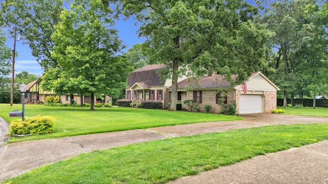 2434 Haven Cove Ln, Chattanooga, TN 37421 - view of front of house featuring brick siding, a front yard, an attached garage, and driveway