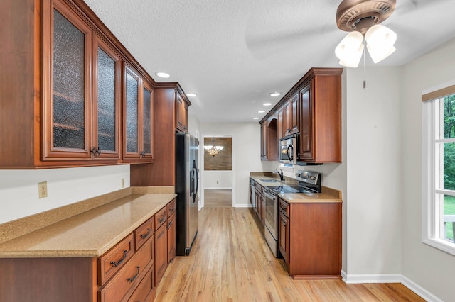 2434 Haven Cove Ln, Chattanooga, TN 37421 - kitchen featuring stainless steel appliances, a sink, light wood finished floors, plenty of natural light, and recessed lighting